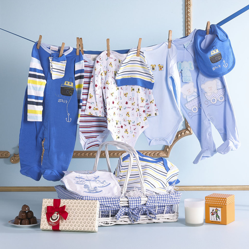 The perfect gift for a new baby boy. Stylish blue clothing for babies aged 3-6 months. Including a box of chocolates and a candle for Mum and Dad, presented in a traditional blue and white wicker basket.Baby boy hamper. Baby gift for boys 