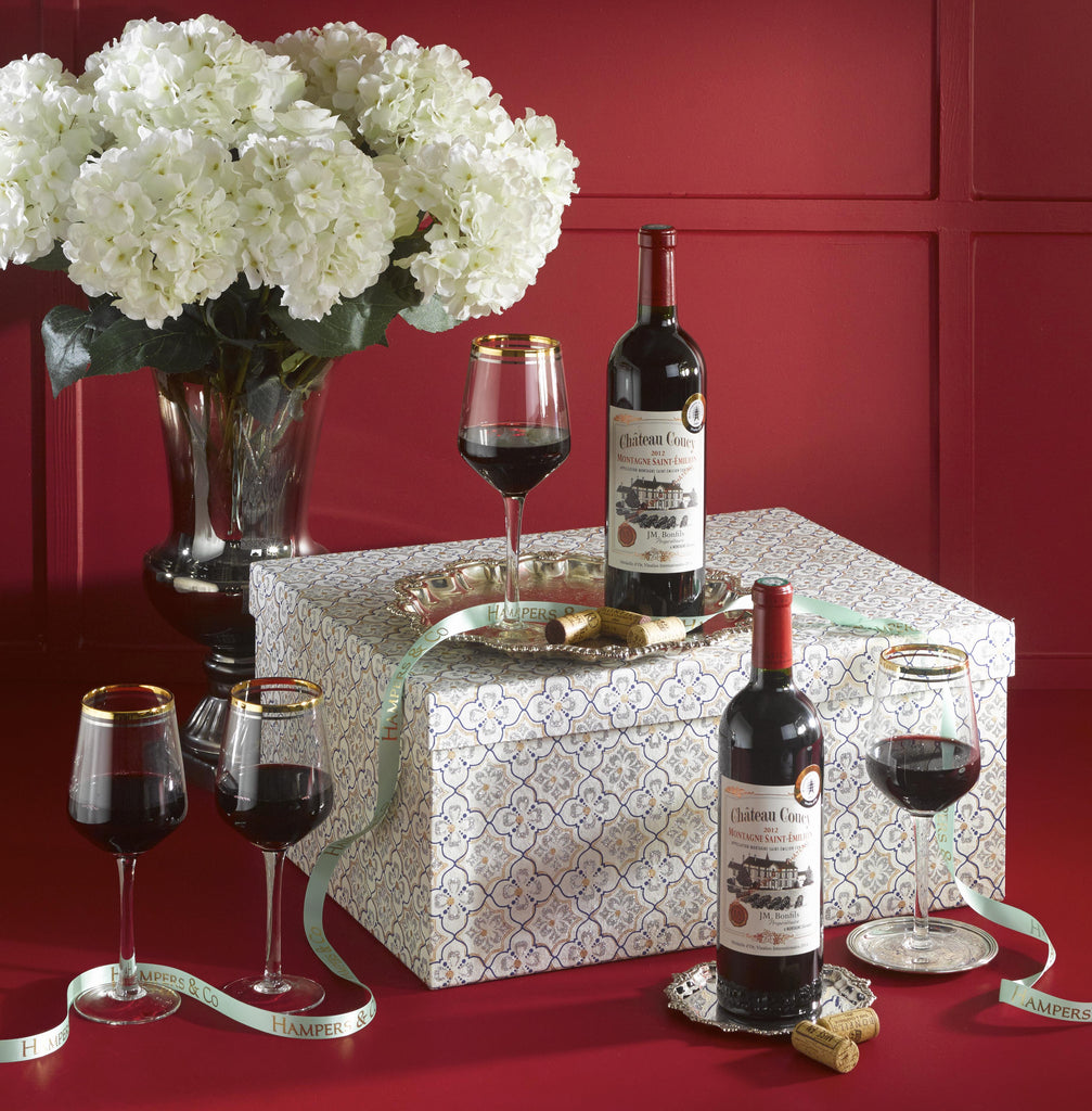 The cheers red wine gift conains two Château Coucy Montagne Saint Emilion 75cl (Gold Medal Award Winner), four Horizon Wine Glasses with a gold rim displayed in a beautiful gift box. A perfect wine gift delivered