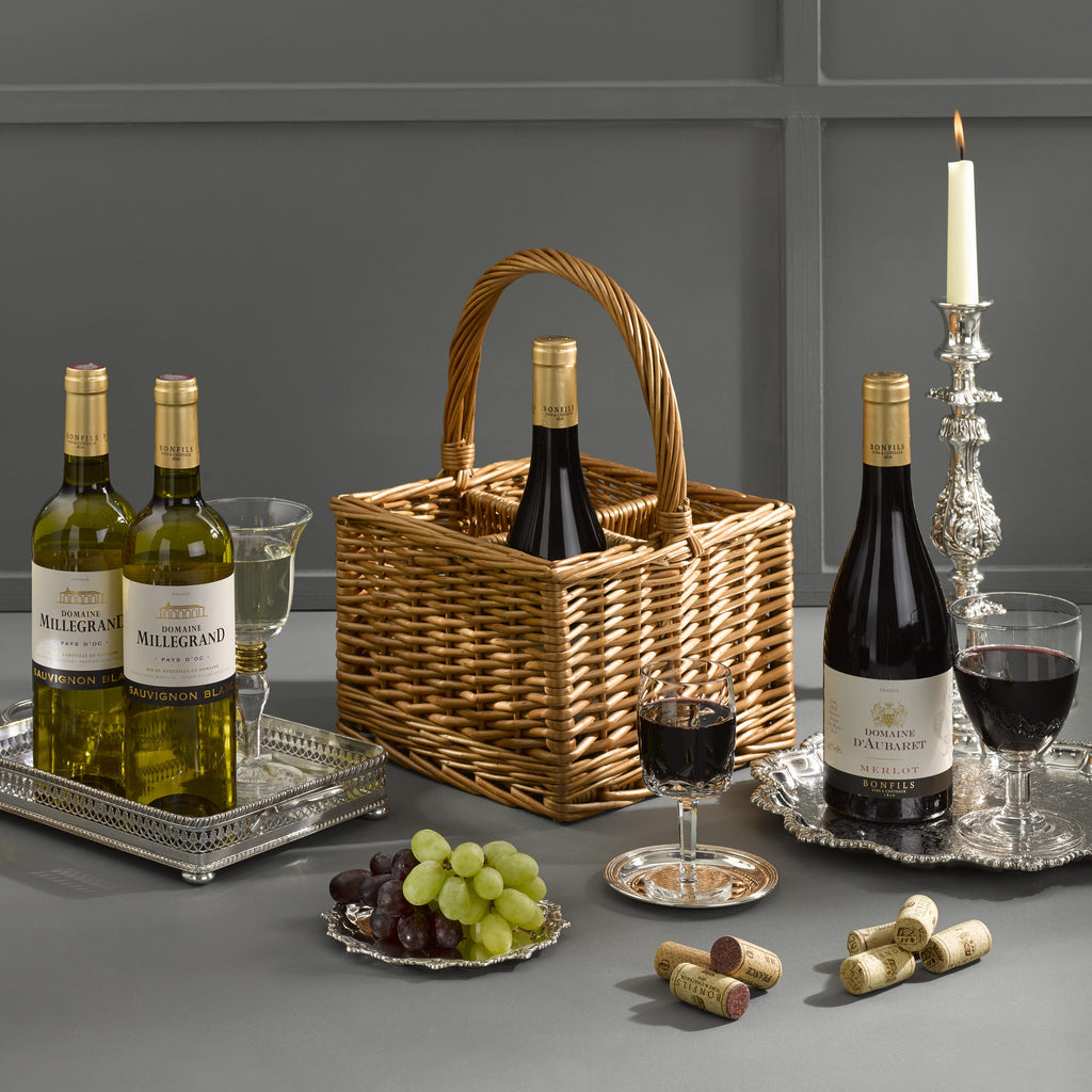 Four bottles of wine (red & white) accompanied with a classic wicker wine carrier. Wine Gift delivered