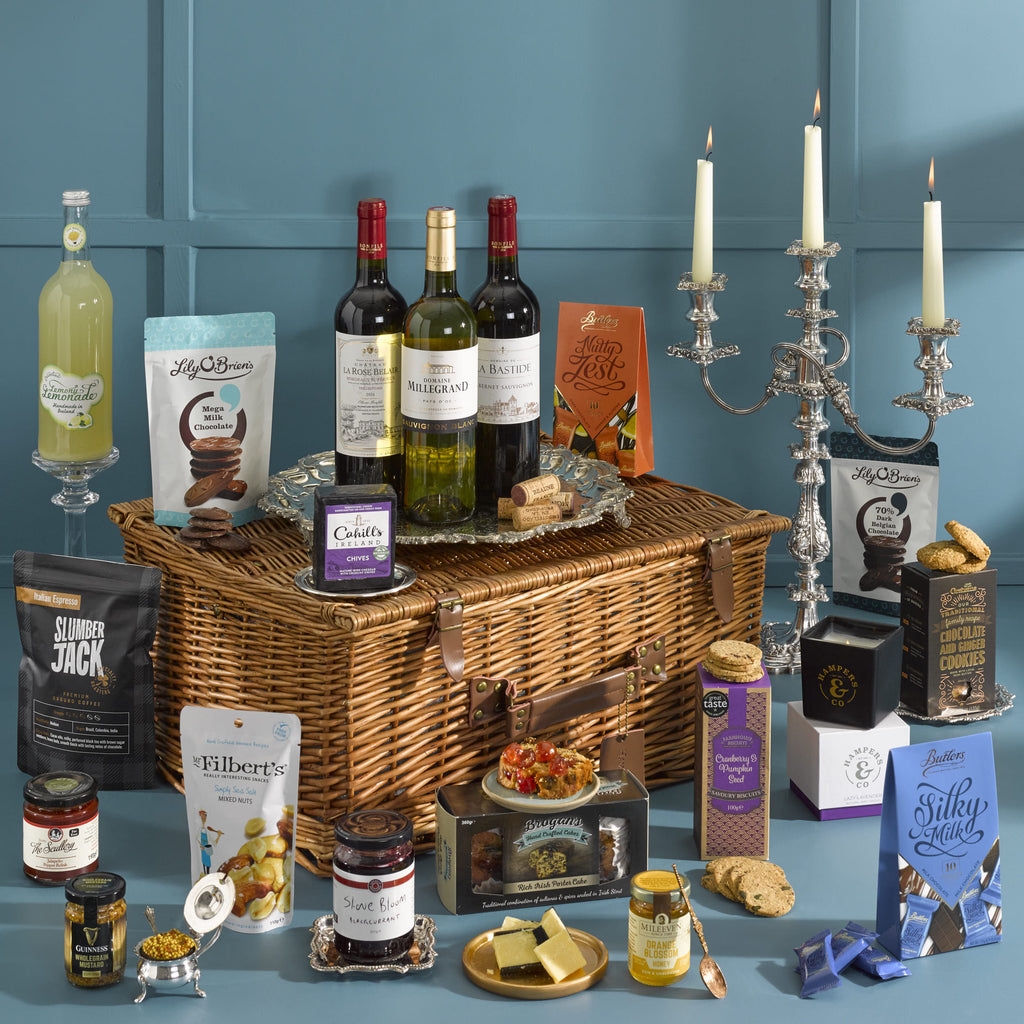 Products Gift Basket of Indulgent Treat. Luxury hampers delivered. Contains a sellection of wines, sweet and savory snacks, cordial, jams, cheese, and candle. Christmas Hampers 