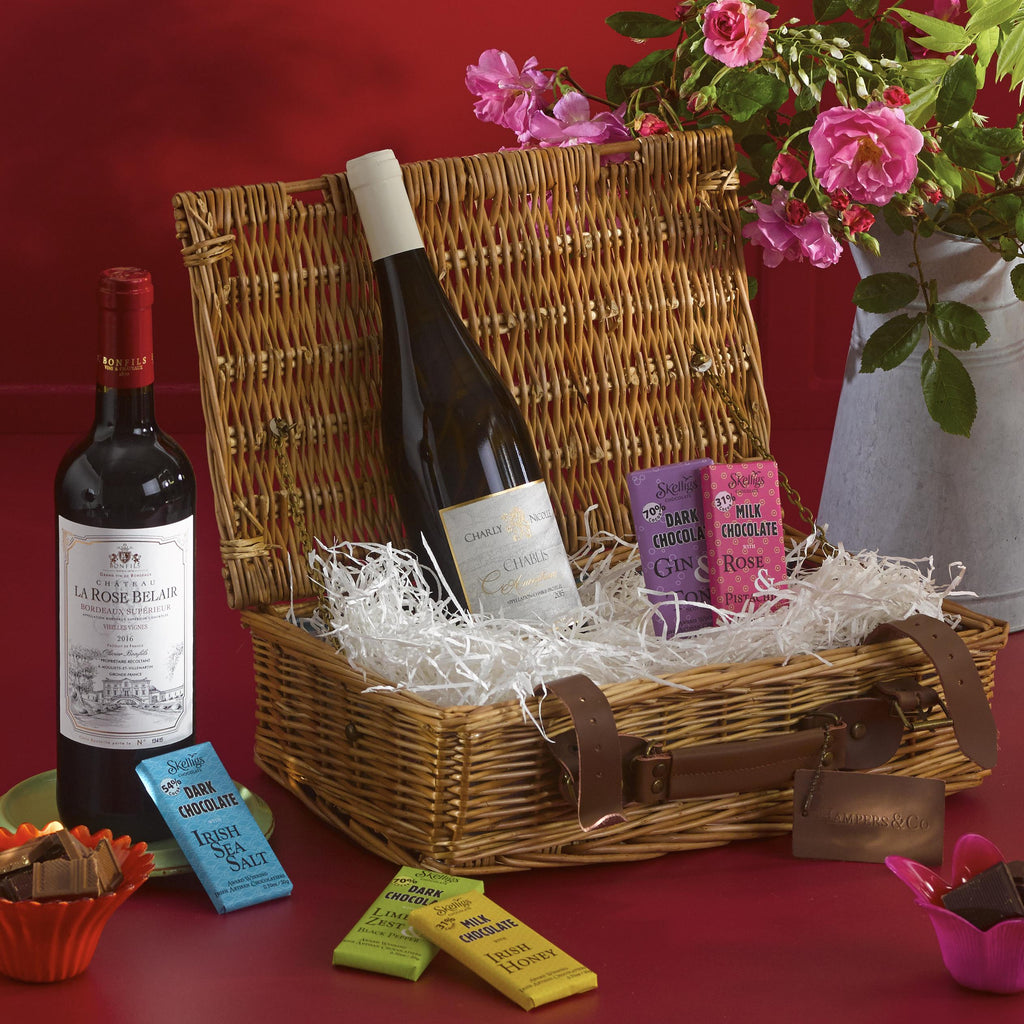 Wine & Chocolates Gift Hamper. Contains two bottles of wine and a selection of chocolates contained in a stylish keepsake basket.